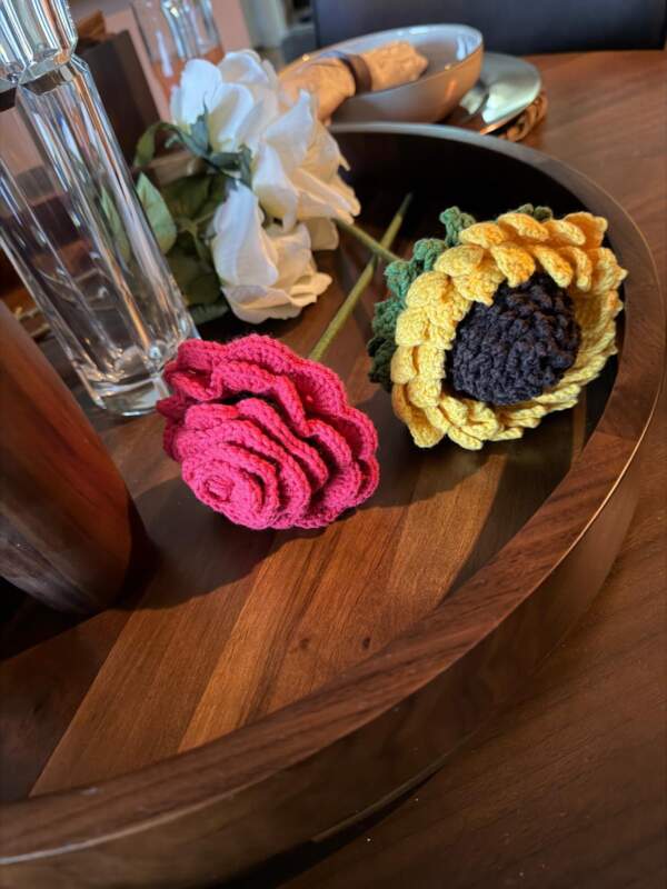 Flowers that transform into hand-knitted dolls.