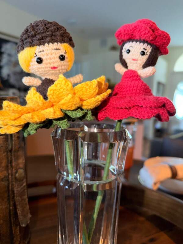 Flowers that transform into hand-knitted dolls.